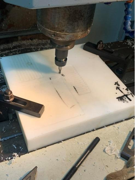 Experimental setup for pocket milling on a polymer workpiece using a CNC milling machine.
